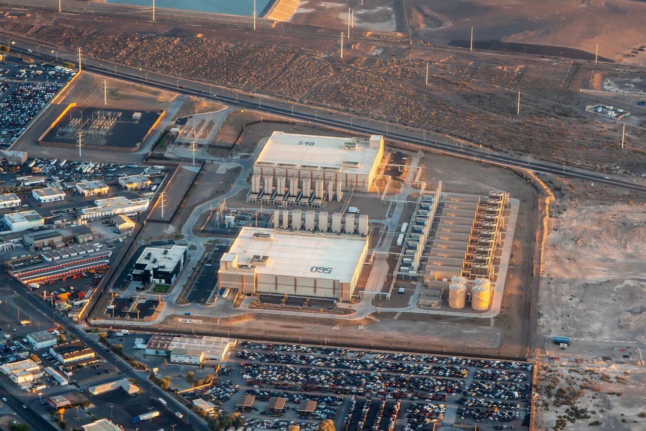 Aerial view of a large industrial facility and water treatment infrastructure in a desert landscape, illustrating how modern manufacturing depends on water systems in water-scarce regions.